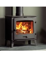 A black wood burning stove, a larger stove to suit a traditional or modern interior with a classic arched window 
