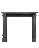 A black cast iron fireplace surround with a simple shaped frame and bullseye pattern indentations