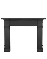 A black cast iron fireplace surround with a broad mantel and square shaped frame