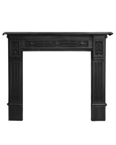 A black cast iron fireplace surround with sunflower motifs and bold floral designs