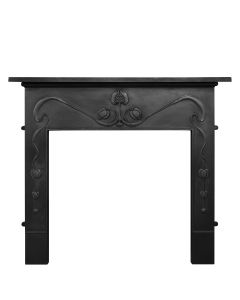 A black cast iron fireplace surround with a linear design in art nouveau style and a pomegranate centrepiece