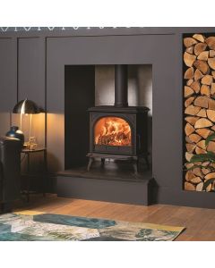 A black wood burning stove, a mid size stove to suit a traditional or modern interior with a classic arched window 
