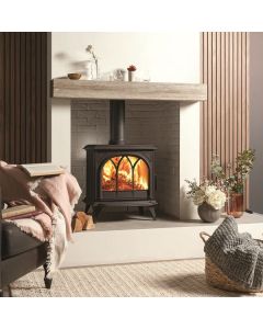 A black wood burning stove, a mid size stove, tracery door for a gothic style stove, wide viewing window
